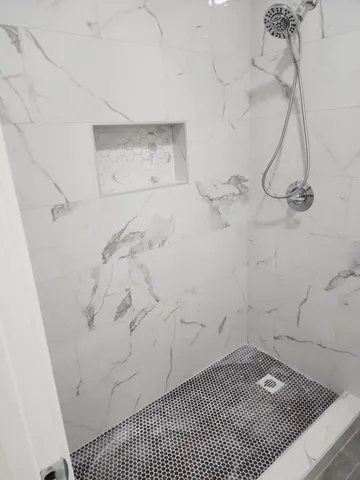 an empty room with furniture and a window