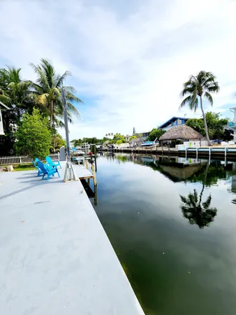 a view of a lake with a table and chairs under an umbrella