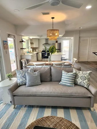 a living room with furniture and a chandelier