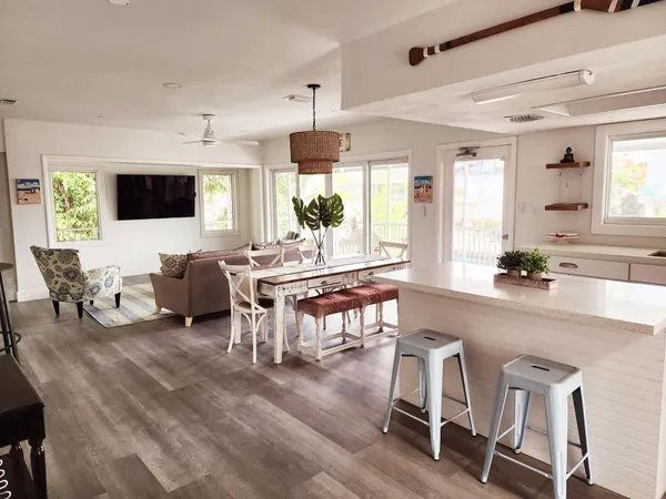 a living room with furniture a flat screen tv and a large window