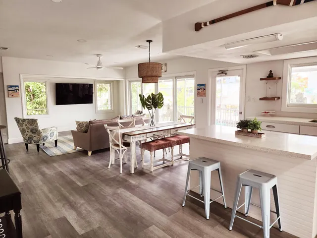 a living room with furniture a flat screen tv and a large window