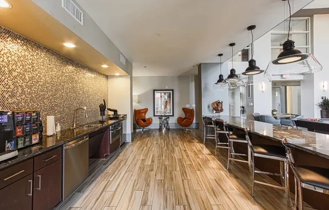 a view of a living room and kitchen with a stove