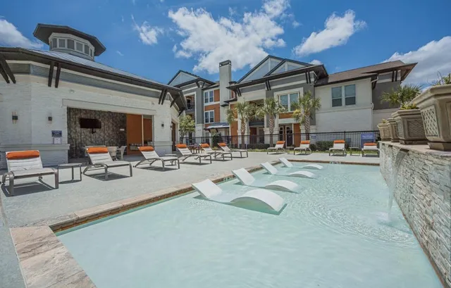 a living room with fireplace furniture and a chandelier