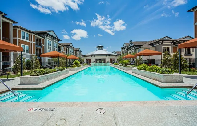 a view of a house with a swimming pool and a yard