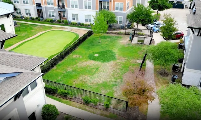 an aerial view of a house with swimming pool and patio