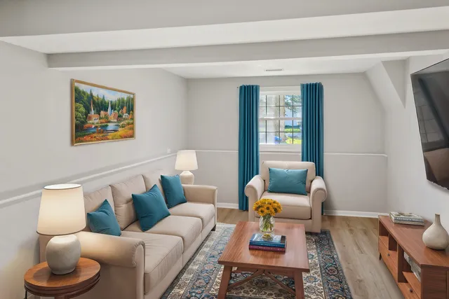 a living room with furniture and a lamp