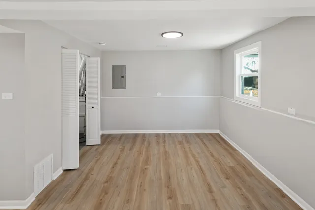 wooden floor in an empty room with a window