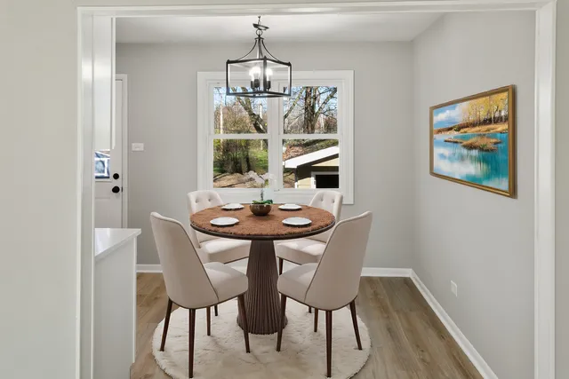 a view of a dining room with furniture and chandelier