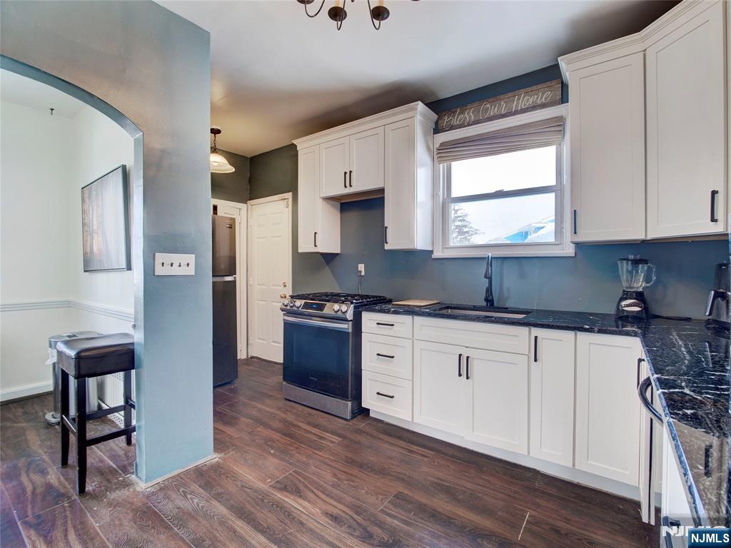 5 Park Road Paterson, NJ 07514 - Photo 13 of 30 a kitchen with stainless steel appliances granite countertop a stove a sink and a refrigerator