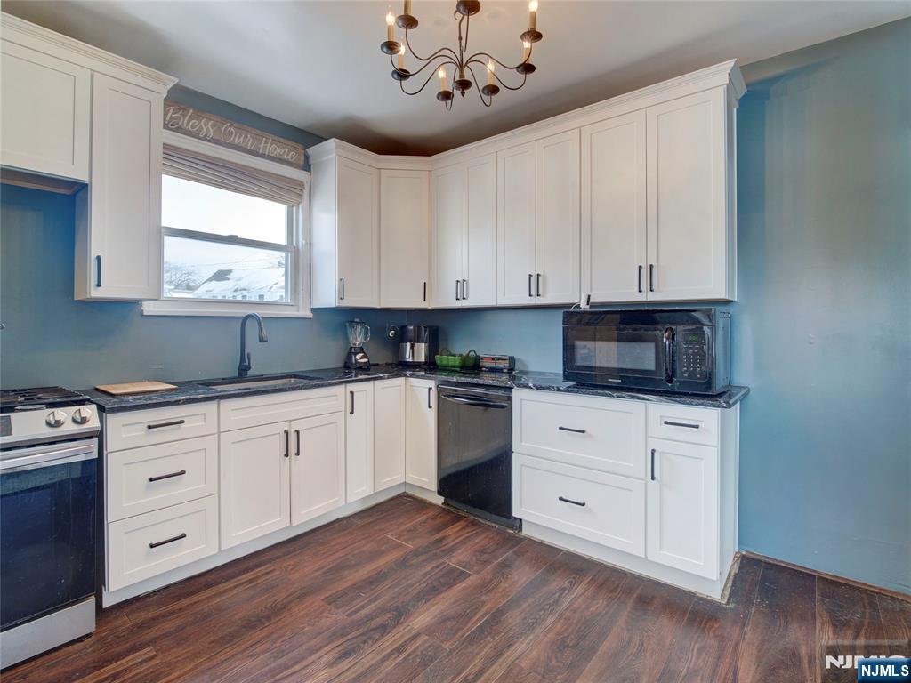 5 Park Road Paterson, NJ 07514 - Photo 15 of 30 a kitchen with stainless steel appliances granite countertop a stove a sink and white cabinets