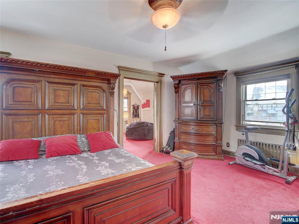 5 Park Road Paterson, NJ 07514 - Photo 28 of 30 a bedroom with a bed and dresser with mirror