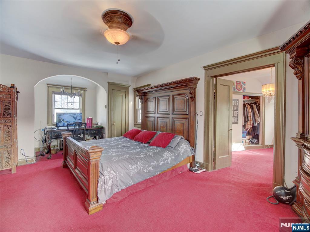 5 Park Road Paterson, NJ 07514 - Photo 29 of 30 a bedroom with a bed and a chandelier