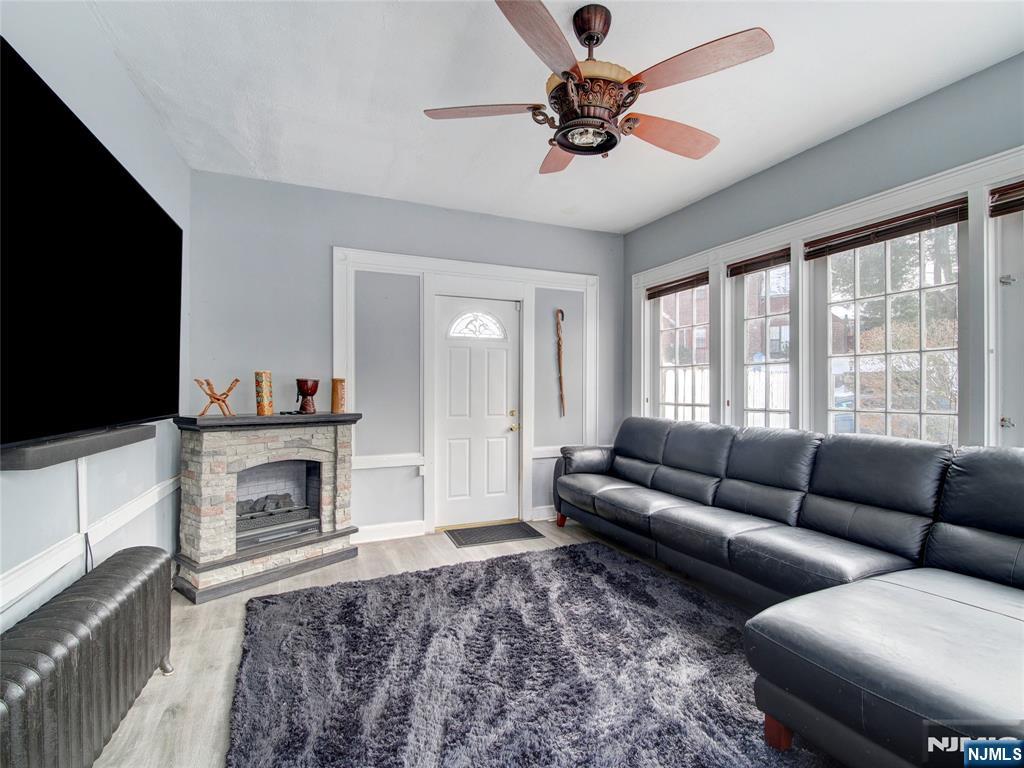 5 Park Road Paterson, NJ 07514 - Photo 4 of 30 a living room with furniture a flat screen tv and a fireplace