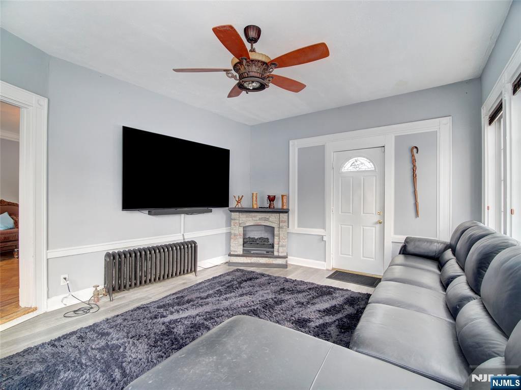 5 Park Road Paterson, NJ 07514 - Photo 5 of 30 a living room with furniture and a flat screen tv