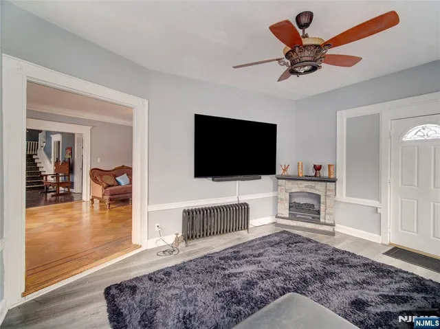 a living room with furniture a fireplace and a chandelier