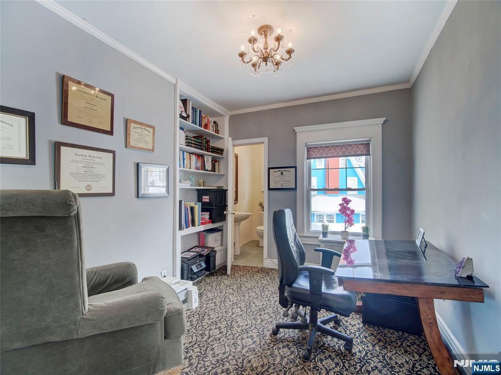 5 Park Road Paterson, NJ 07514 - Photo 10 of 30 a workspace with furniture and book shelf