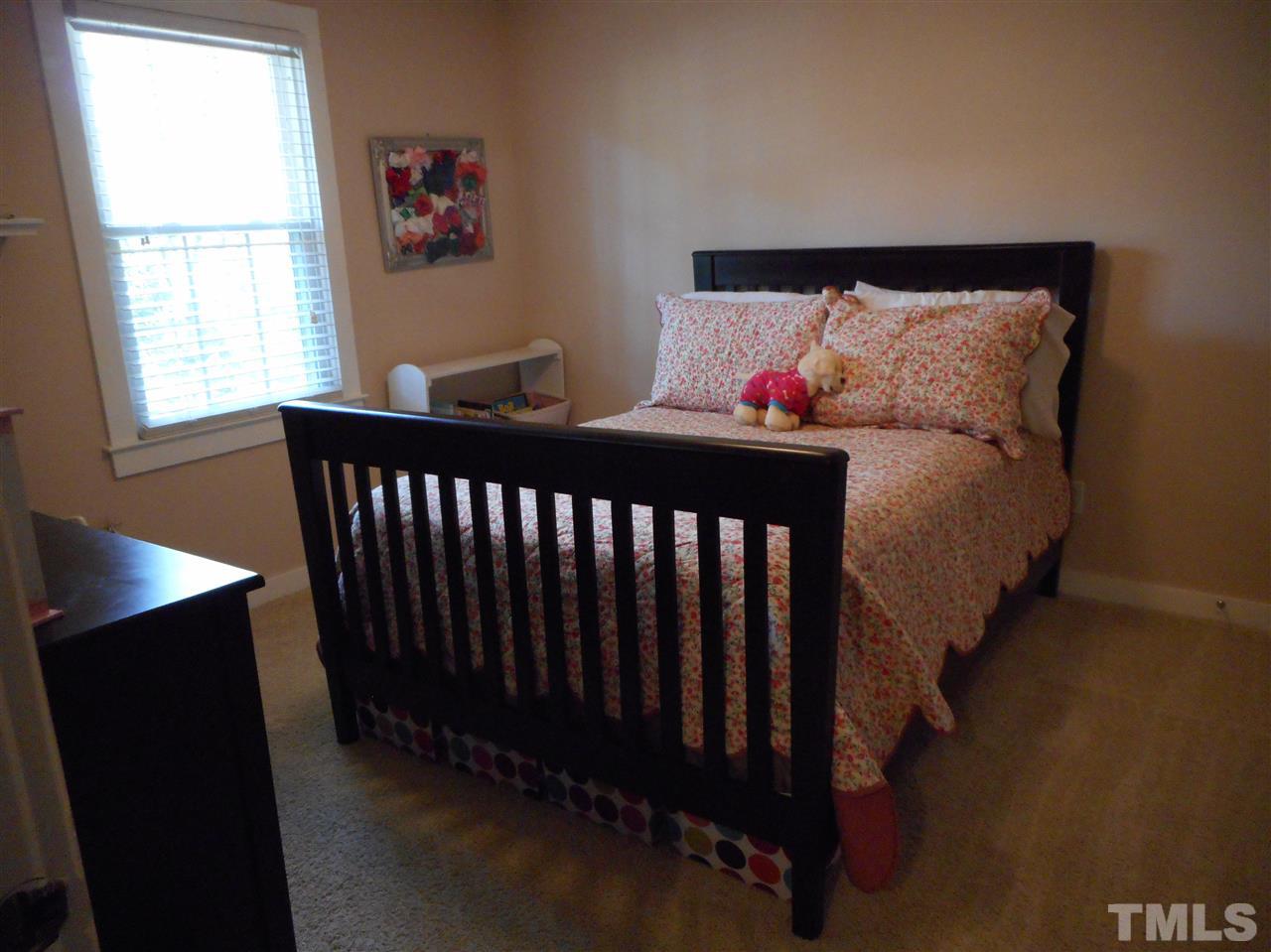 2616 Howard Road Raleigh, NC 27613 - Photo 11 of 16 a bed sitting in a bedroom next to a window