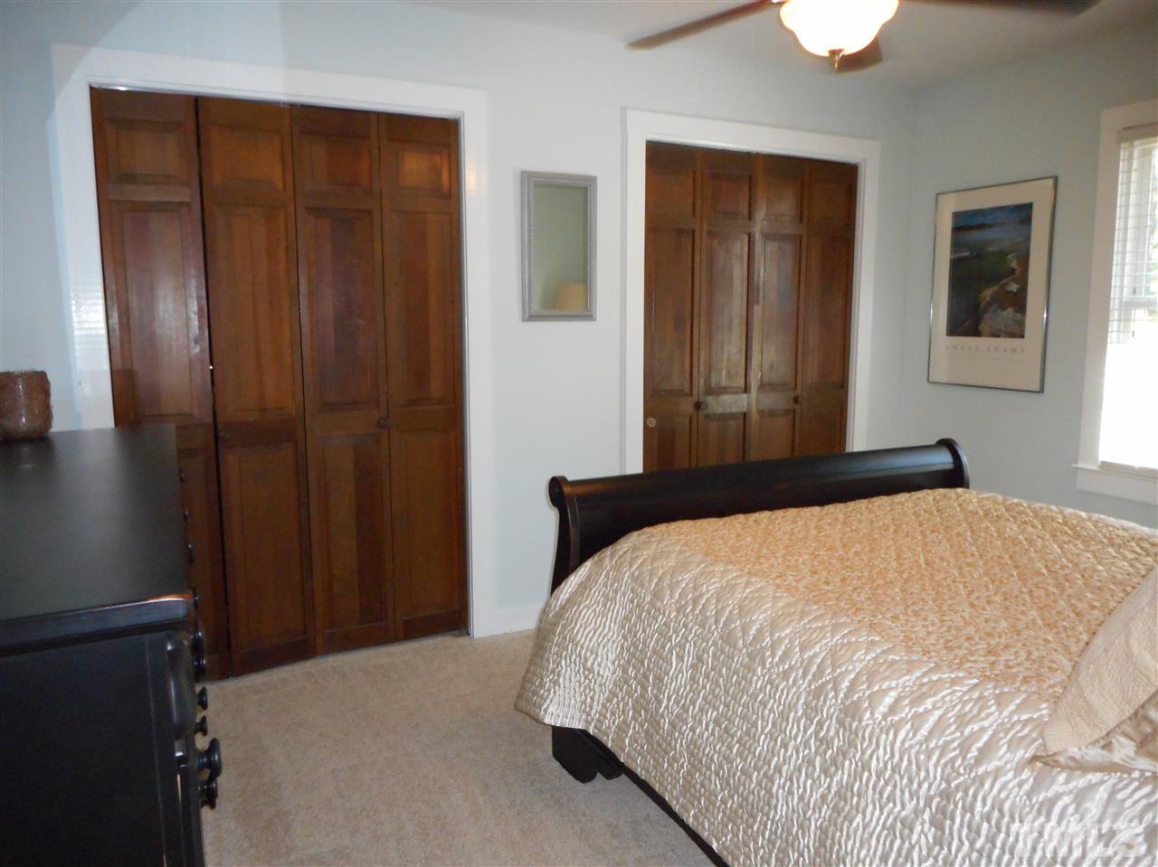 2616 Howard Road Raleigh, NC 27613 - Photo 12 of 16 a bedroom with a bed and a mirror