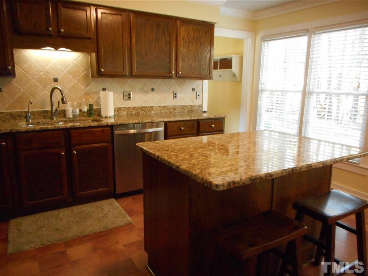 2616 Howard Road Raleigh, NC 27613 - Photo 6 of 16 a kitchen with granite countertop sink cabinets and window