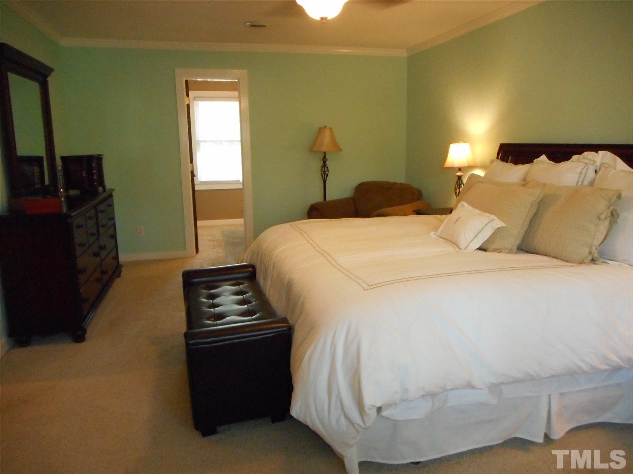 2616 Howard Road Raleigh, NC 27613 - Photo 9 of 16 a bedroom with a bed and a couch
