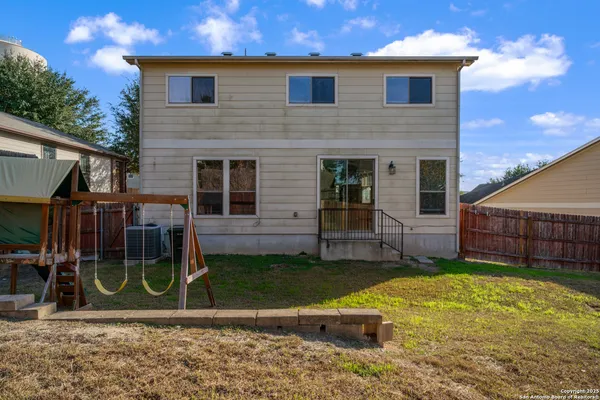 a view of a house with a yard and sitting area