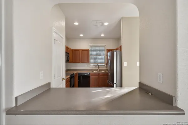 a kitchen with stainless steel appliances granite countertop a sink stove microwave and refrigerator