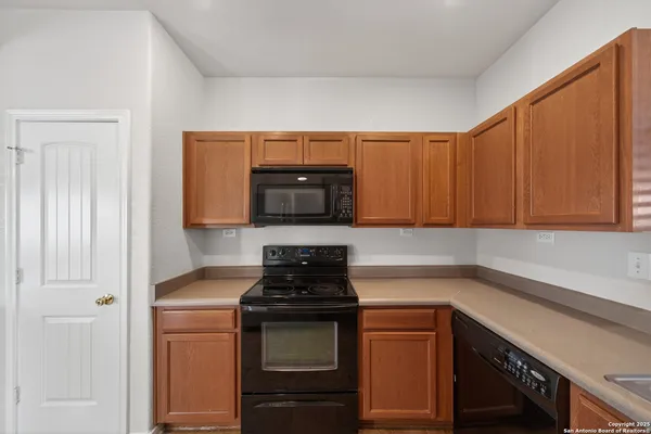 a kitchen with stainless steel appliances granite countertop a refrigerator stove and sink