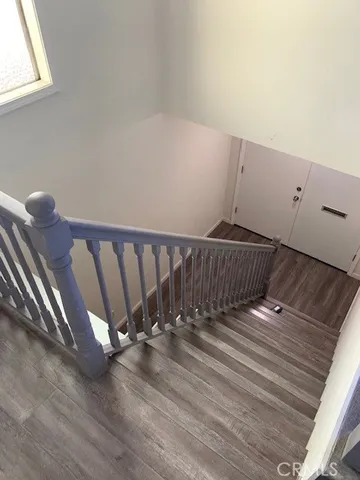 a view of a room with wooden floor