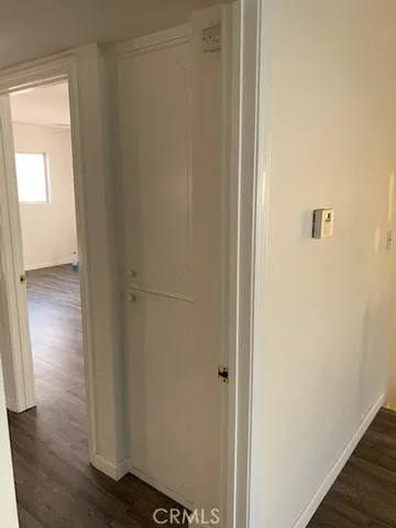 a view of hallway with wooden floor