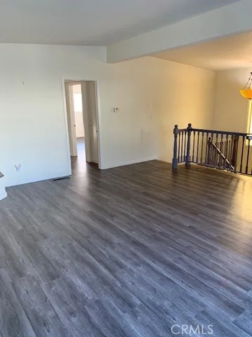 a view of a room with wooden floor