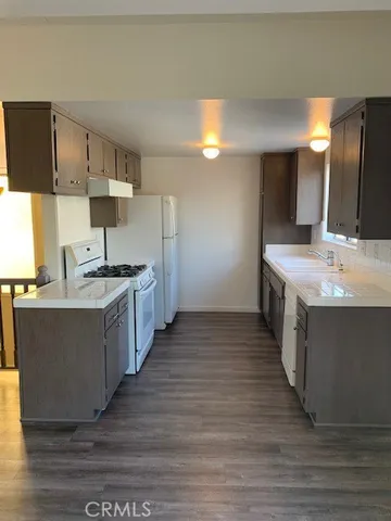a kitchen with a sink and a stove top oven