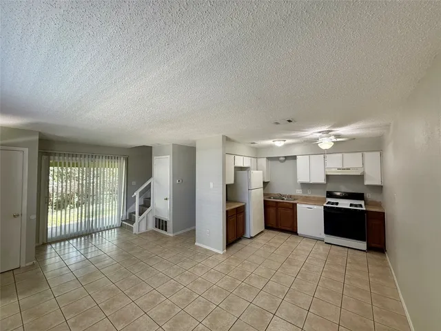 a large kitchen with cabinets and stainless steel appliances