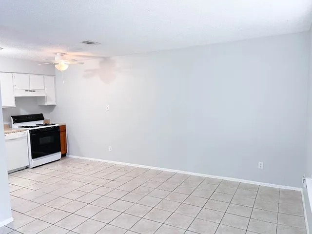 a view of a room with white walls and sliding door