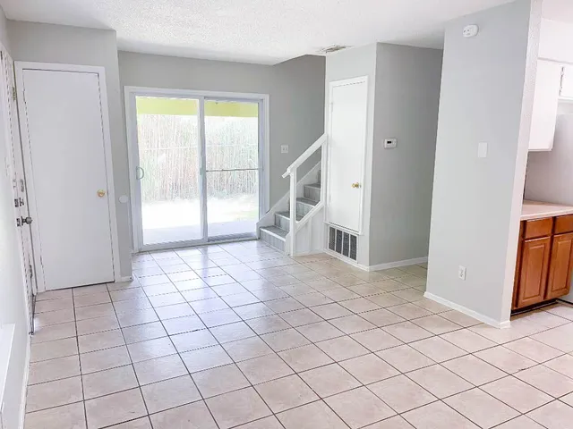 a view of a hallway with bathroom and entryway