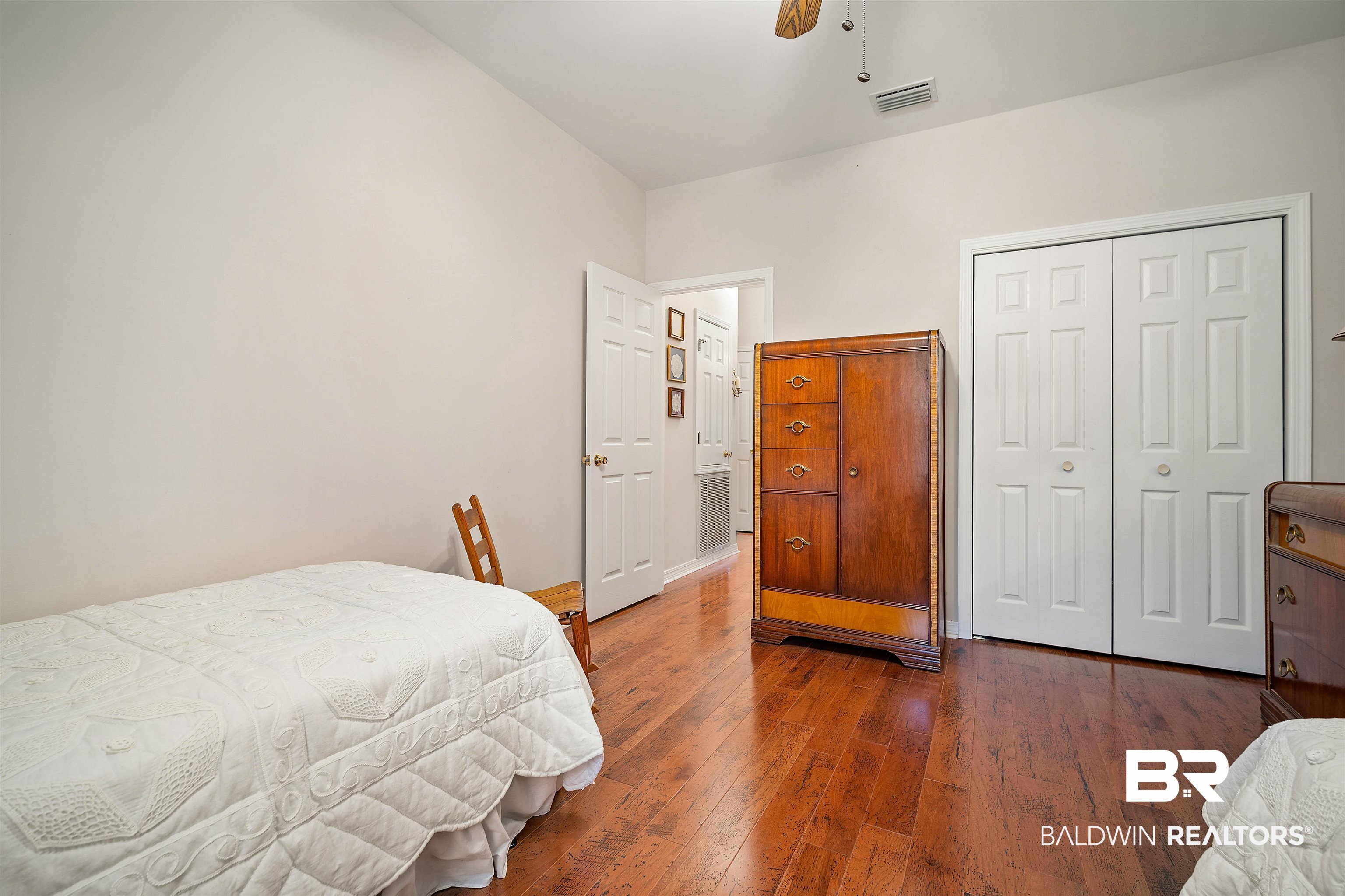 7419 Pake Road Saraland, AL 36571 - Photo 21 of 27 Bedroom featuring ceiling fan, dark hardwood / wood-style flooring, and a closet