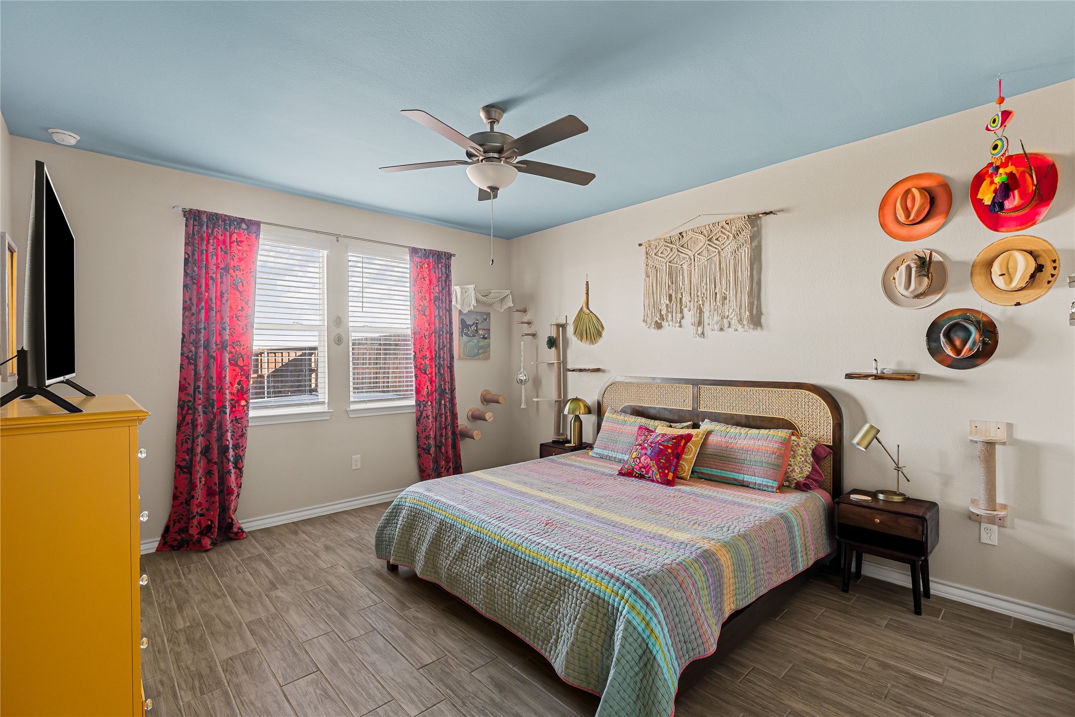 862 Pepperbark Loop Buda, TX 78610 - Photo 16 of 40 a bedroom with a bed a dresser and a window