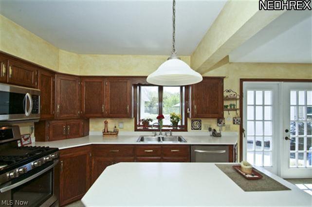 2985 Mill Ridge Circle Northwest Canton, OH 44708 - Photo 6 of 25 Kitchen with Center Island and French Doors to Patio. You'll find newer Stainless Steel appliances.