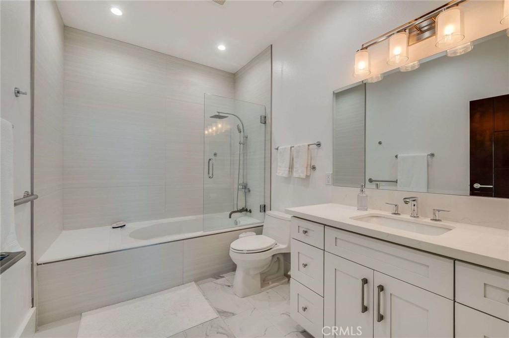 11837 Rideout Way Whittier, CA 90601 - Photo 19 of 44 a bathroom with a sink a toilet and shower