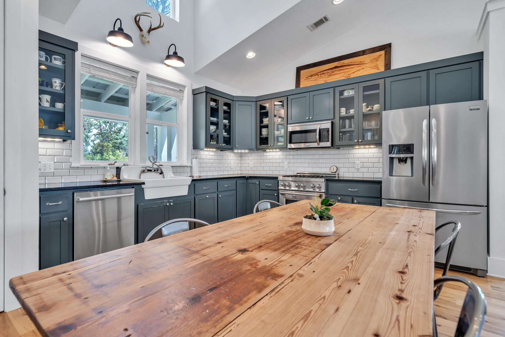 192 Buck Road Santa Rosa Beach, FL 32459 - Photo 13 of 74 a kitchen with stainless steel appliances kitchen island granite countertop a sink refrigerator dining table and chairs