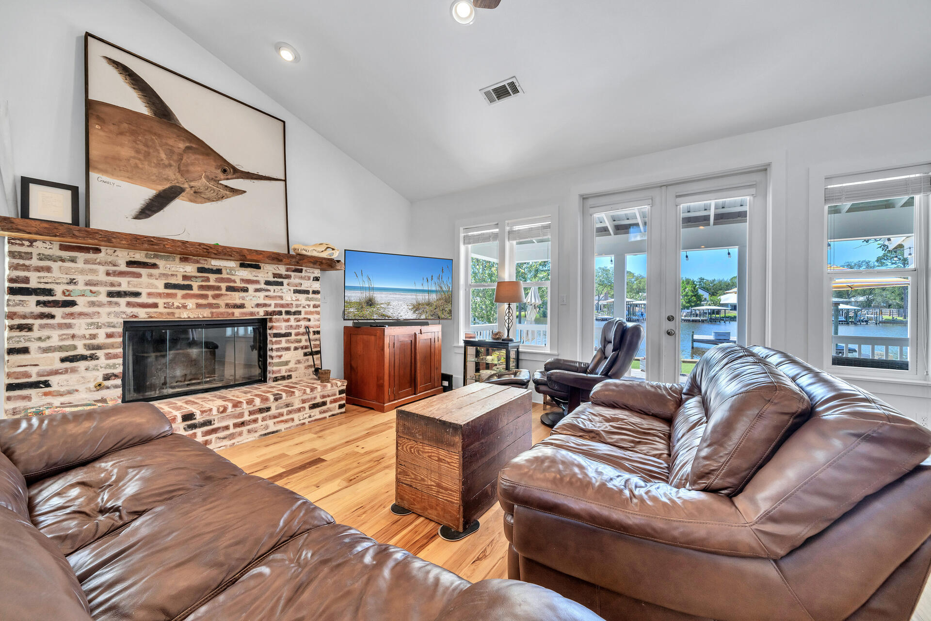 192 Buck Road Santa Rosa Beach, FL 32459 - Photo 15 of 74 a living room with furniture a fireplace and a large window