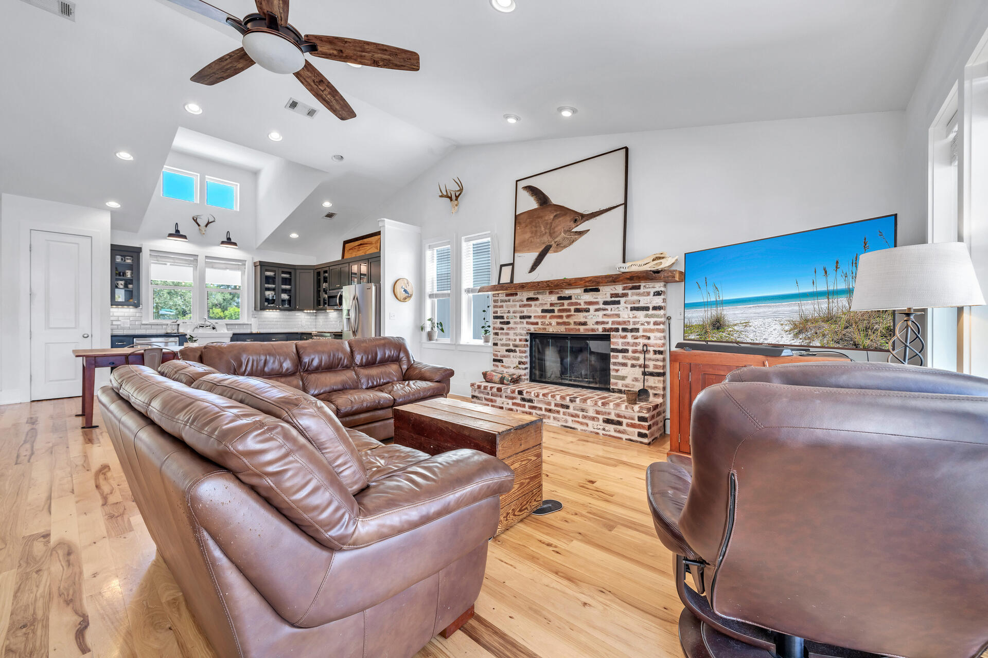 192 Buck Road Santa Rosa Beach, FL 32459 - Photo 16 of 74 a living room with furniture a fireplace and a ceiling fan