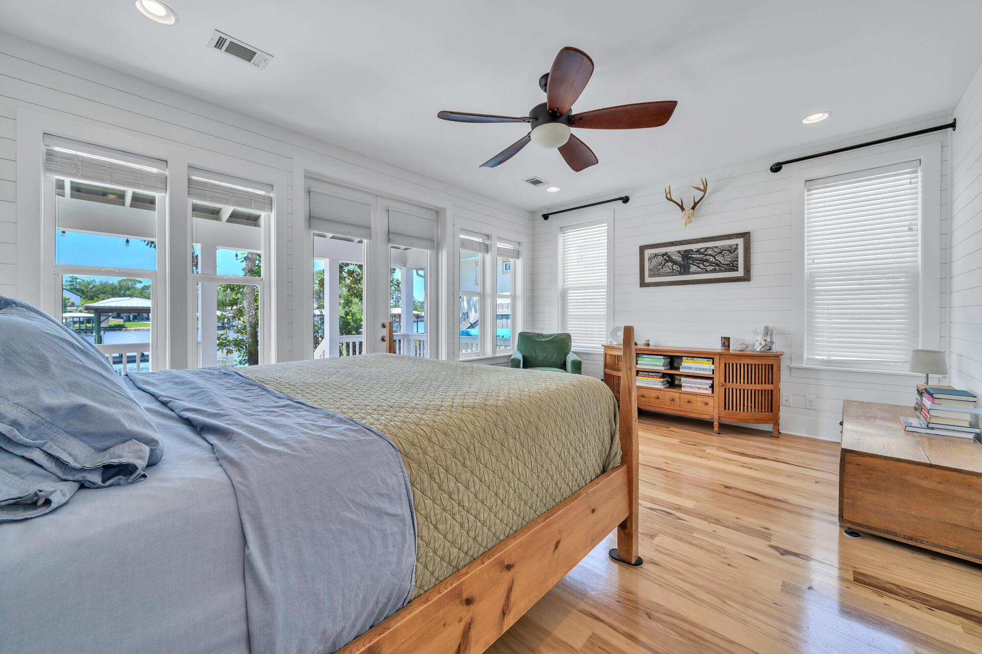 192 Buck Road Santa Rosa Beach, FL 32459 - Photo 21 of 74 a spacious bedroom with a bed a table and large windows