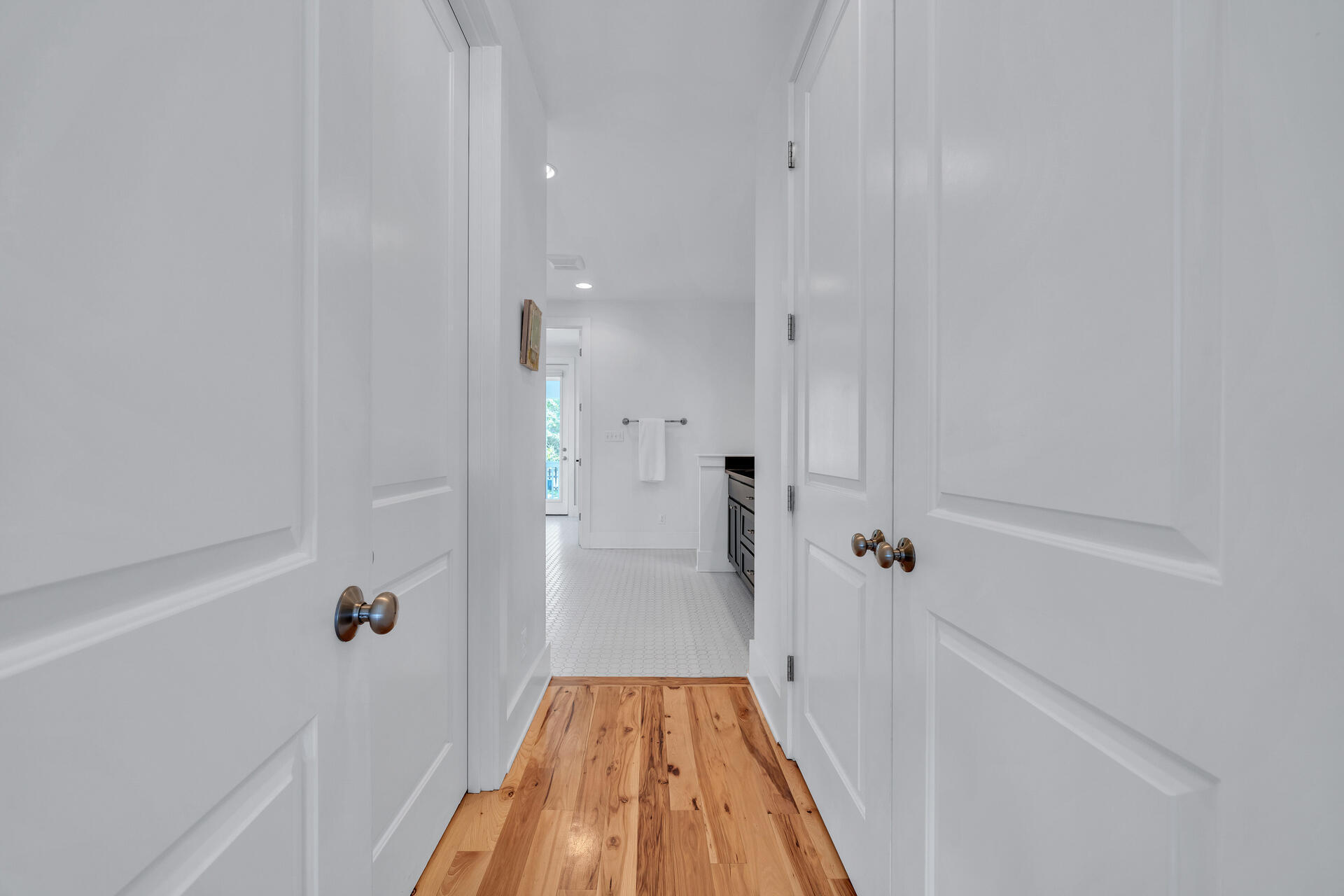 192 Buck Road Santa Rosa Beach, FL 32459 - Photo 23 of 74 a view of a hallway with wooden floor and a bathroom