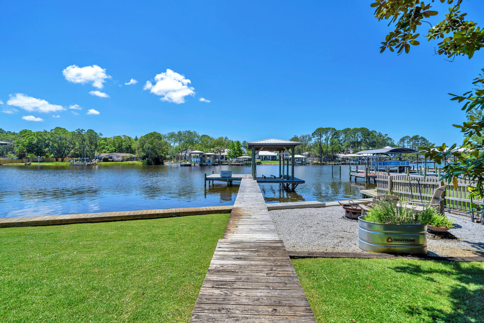 192 Buck Road Santa Rosa Beach, FL 32459 - Photo 55 of 74 a view of a lake with a garden