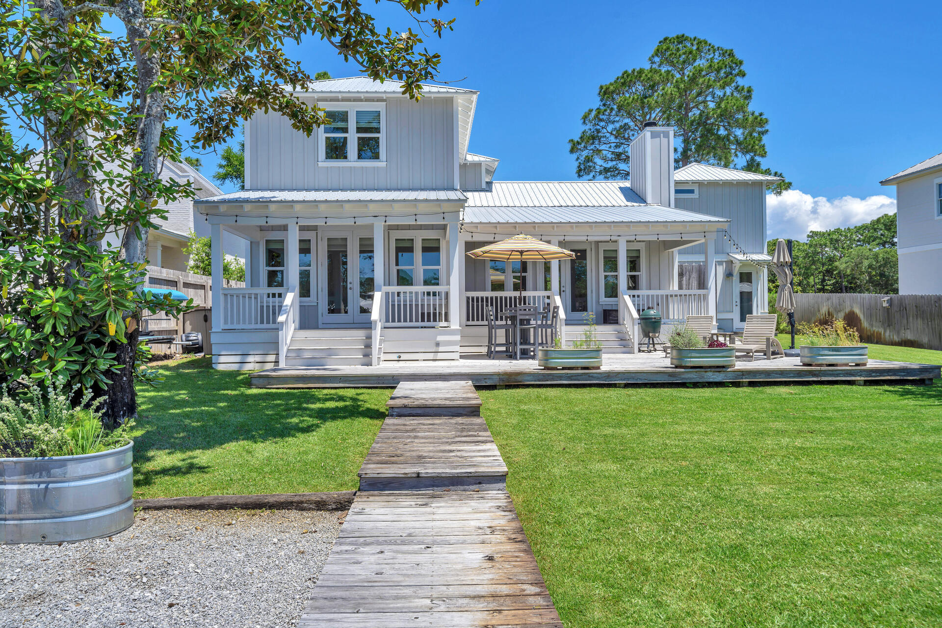 192 Buck Road Santa Rosa Beach, FL 32459 - Photo 65 of 74 a front view of a house with garden and sitting area