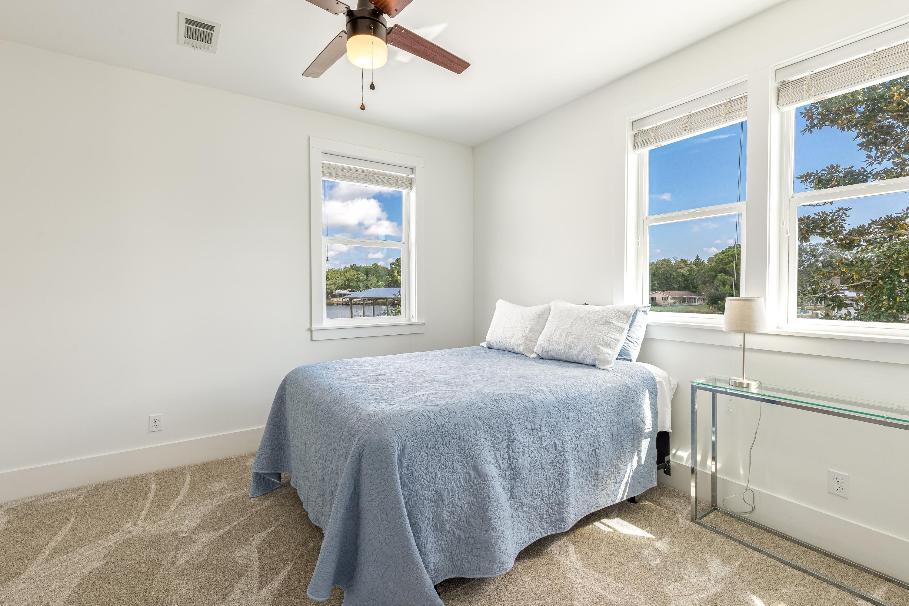 192 Buck Road Santa Rosa Beach, FL 32459 - Photo 70 of 74 a bedroom with a bed and a window