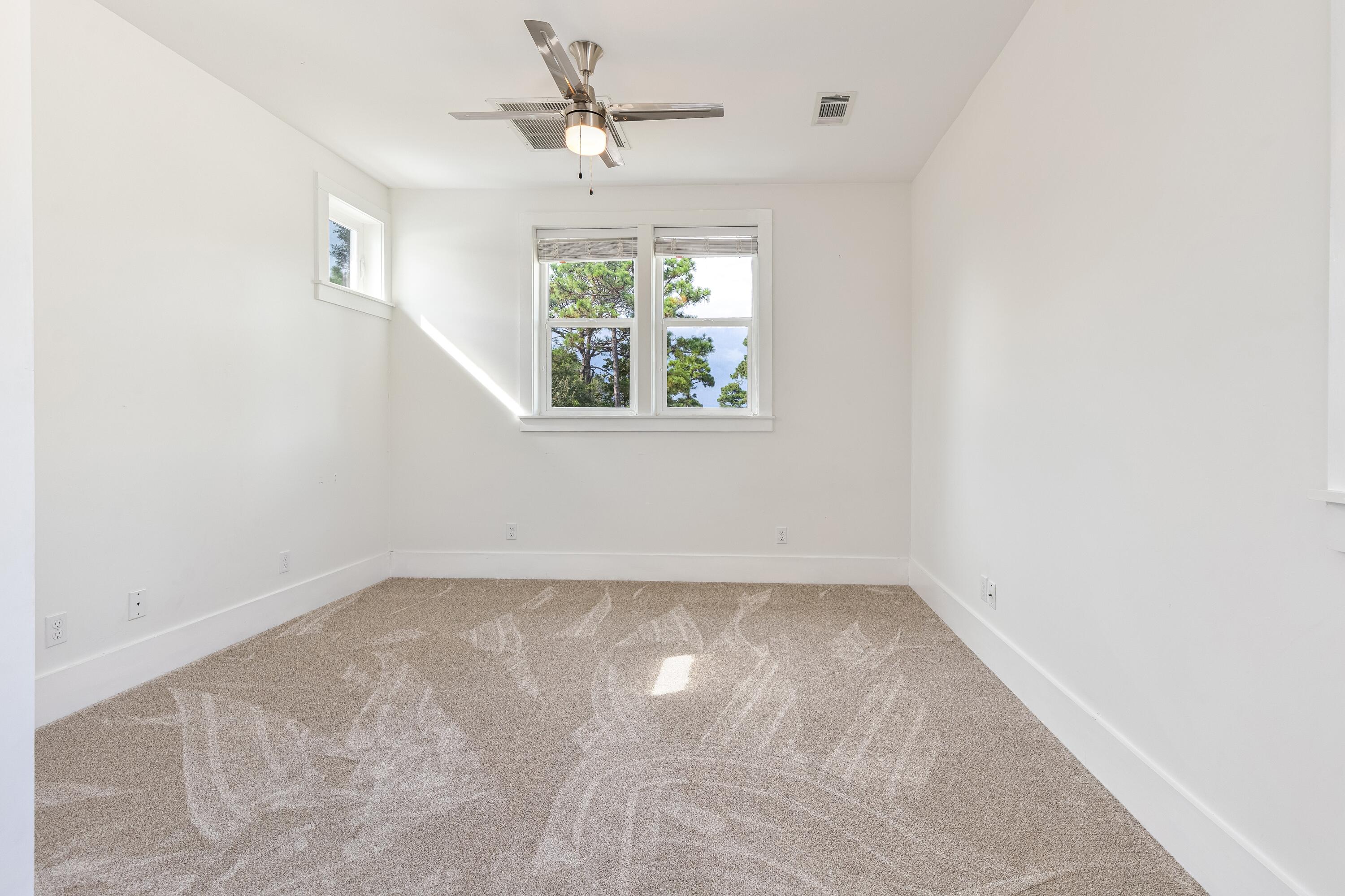 192 Buck Road Santa Rosa Beach, FL 32459 - Photo 73 of 74 an empty room with windows and fan