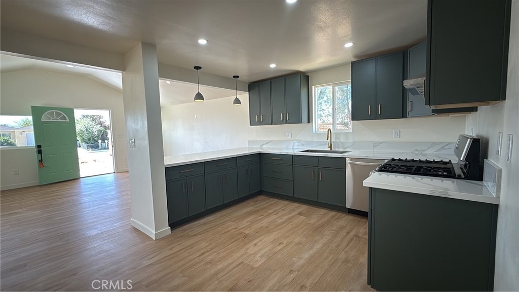716 West Church Avenue Ridgecrest, CA 93555 - Photo 3 of 20 a kitchen with stainless steel appliances granite countertop a sink a stove a refrigerator and cabinets