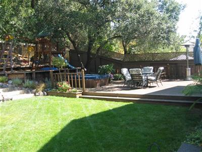 3360 Andy Way Santa Rosa, CA 95404 - Photo 11 of 12 Professionally landscaped backyard with deck, spa and play structure offers privacy and a shaded retreat during hot summer days