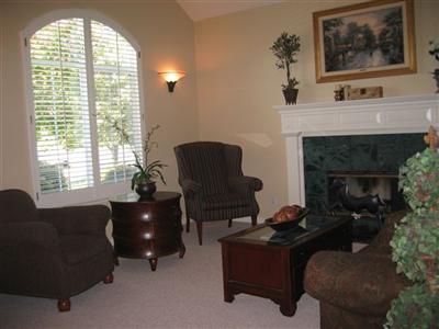 3360 Andy Way Santa Rosa, CA 95404 - Photo 2 of 12 Formal sitting area of living/dining room with fireplace, vaulted ceilings and plantation shutters